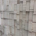 Pre-cut deflection head strips for London construction sites, stacked ready for site delivery