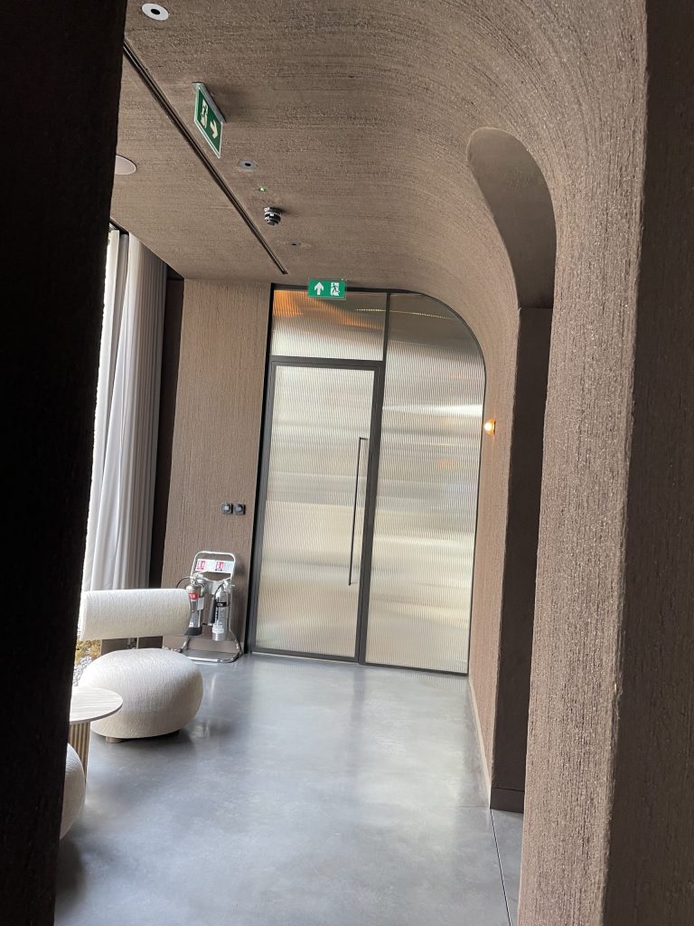 Curved plasterboard wall and ceiling detail showing textured finish and doorway arch